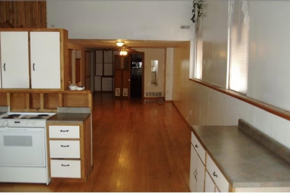 Sample unit kitchen and open living area with hardwood floors